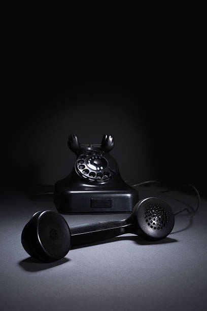 istock Handset and vintage rotary phone on dark background 499631972