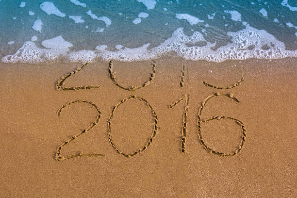istock Happy New Year 2016 replace 2015 concept on sea beach 499632412