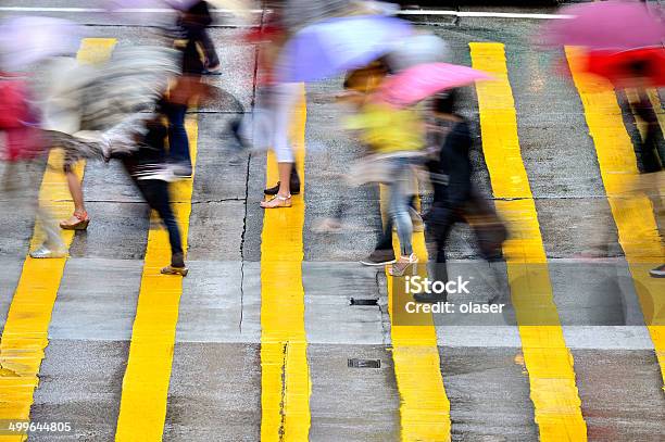 Motion Blurred Pedestrians Crossing Hong Kong Street In The Rain Stock Photo - Download Image Now