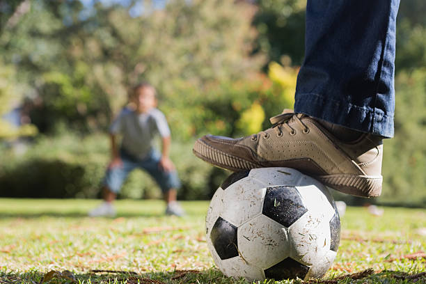 istock Father and son playing football 499644975
