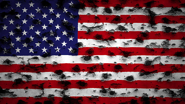 istock USA flag painted on wall with bullet holes 499647492