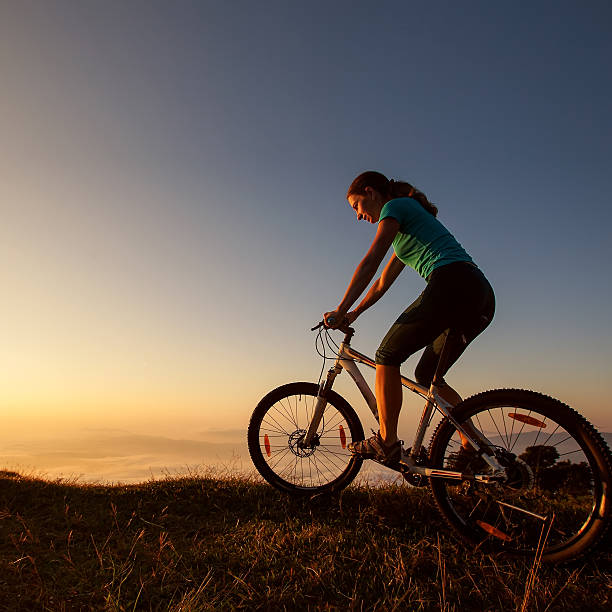 istock Biker-girl at the sunset on mountains 499647586
