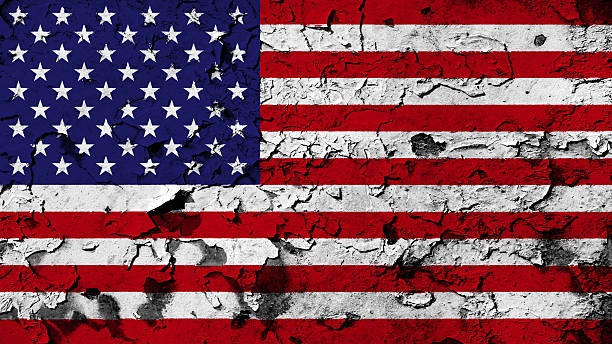 istock USA flag painted on cracked paint texture. 499648408