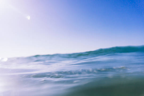 Side sun and water flare on the sea surface at Porthcurno South Cornwall with Sony A6000 and underwater housing.