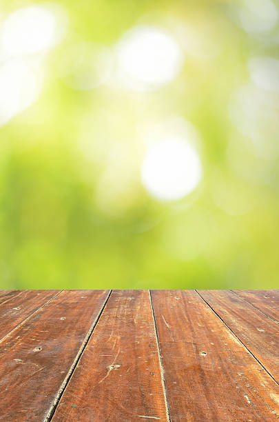 istock Empty wood table and green bokeh abstract background 499649902