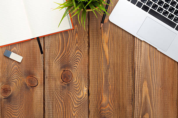 istock Office desk table with computer, supplies and flower 499650340