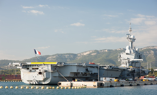 Toulon, France - October 29, 2014: The French aircraft carrier Charles de Gaulle in Toulon Harbour where the French navy is moored when not involved in missions. The Charles de Gaulle is the largest naval vessel in Western Europe and weighs 38,000 tonnes. It is also the only one powered by nuclear energy.