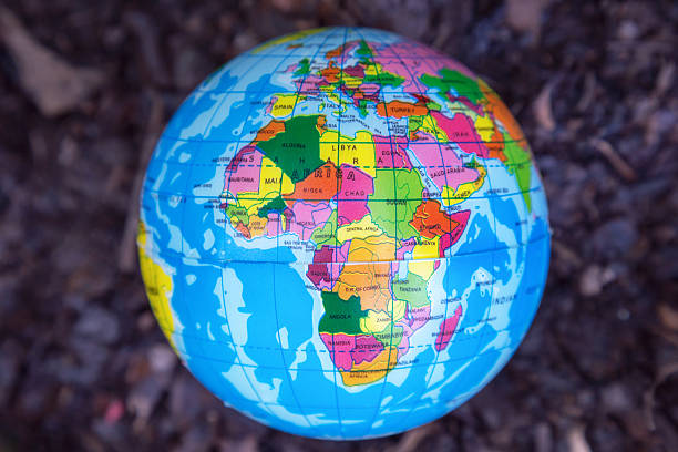 istock global ball toy on soil background, environment concept 499652016