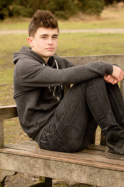 istock Teenage Boy Sitting on A Bench 499655766