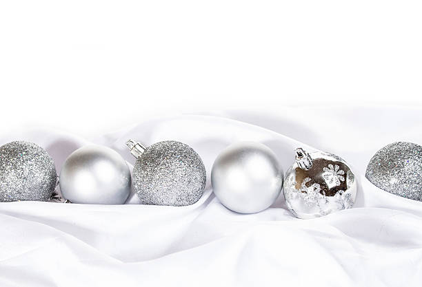 istock silver Christmas ballson white silk background 499655858