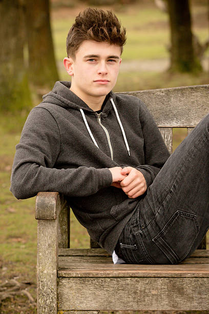 istock Teenage Boy Sitting on A Bench 499656666