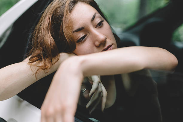 Tired girl looking out of the car window