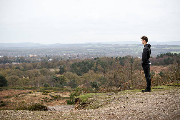 istock Teenage Boy Looking Over A Landcape 499656948