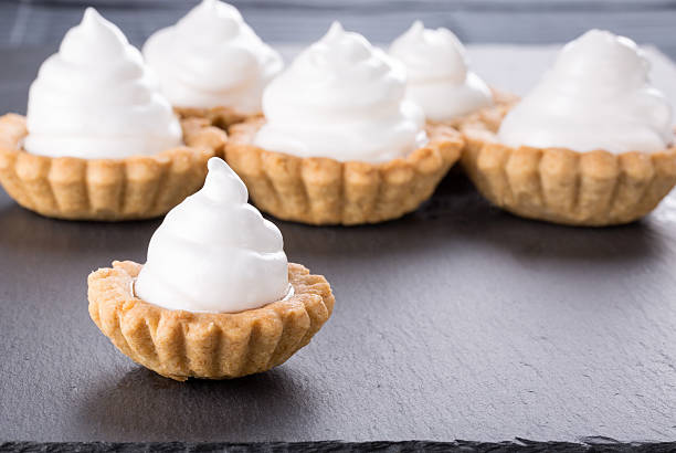istock Shortcrust tartlets with jam and Italian meringue. 499657534