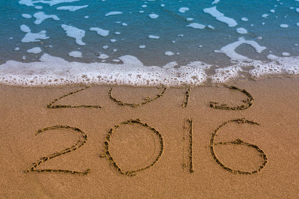 istock Happy New Year 2016 replace 2015 concept on sea beach 499658802