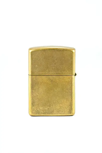 Brass metal zippo lighter isolated on white background.