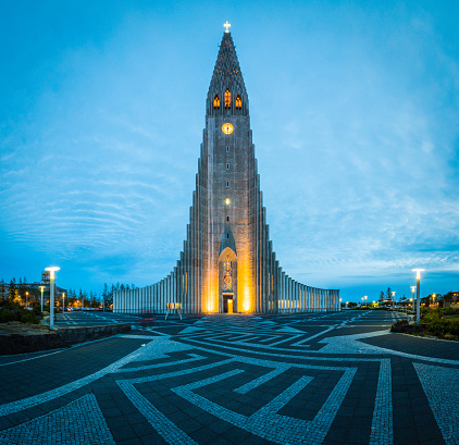 The futuristic spire and concrete columns of Hallgrimskirkja, the iconic Lutheran church in the heart of downtown Reykjavik, Iceland's vibrant capital city. ProPhoto RGB profile for maximum color fidelity and gamut.