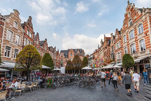 Leuven, Belgium - September 15, 2014: Students sit at the outdoor tables of the Oude Markt, a large rectangular square also known as the \