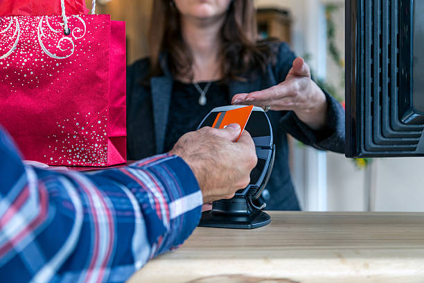 Man Paying With NFC Technology on Credit Card in Store