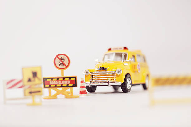 istock Yellow school bus ( toy model ) with traffic signs. 499660912