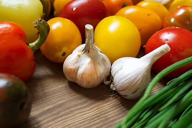 istock Garlic bulbs and vegetables still life, top view 499661330