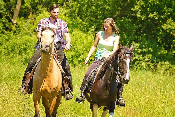 istock young beautiful couple riding with horse 499661805