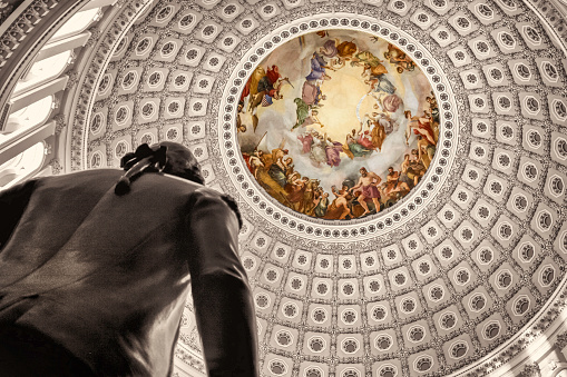 Close up view of the intricate detail of the U.S. Capitol Rotunda ceiling and silhouette of George Washington. 