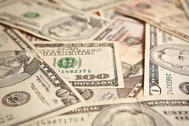 istock 100 Dollar Bill Standing Out In A Crowd 499662104