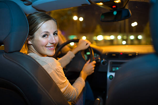istock Woman driving car at night 499664025