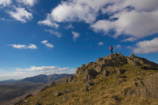 Female hiker standing on mountain stock photo