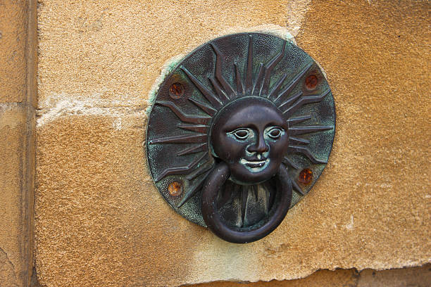 istock Ornamental sunshine door knocker on Bathstone wall, by front door 499666171