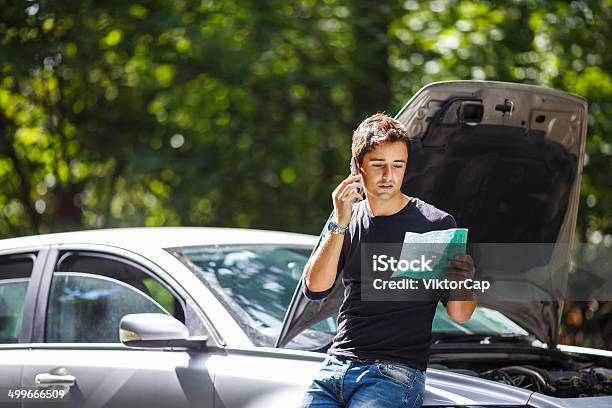 Handsome Young Man Calling For Roadside Assistance Stock Photo - Download Image Now - Breaking, Car, Moving Down