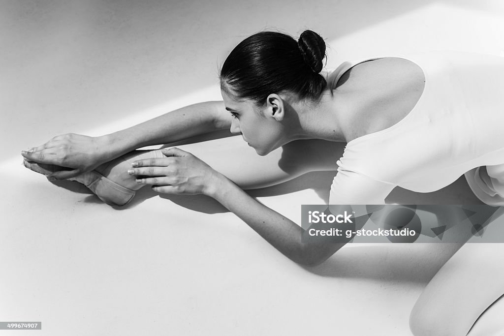 Working hard to be the best. Top view of beautiful young ballerina doing stretching exercises Adult Stock Photo