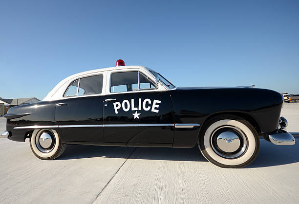 Old American police car parked side view