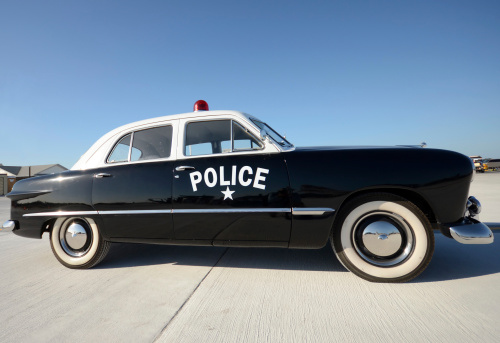 Old American police car parked side view