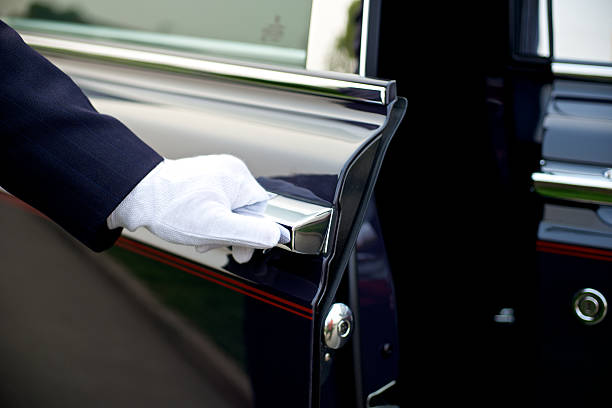 Luxury Chauffeur service Luxury service with chauffeur opening the door butler stock pictures, royalty-free photos & images
