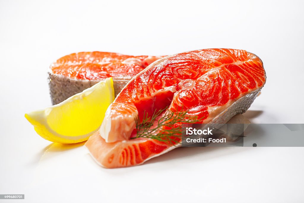 Fresh raw salmon isolated on white background. Fresh raw salmon isolated on white background. Lemon lobule and fennel Cooking Stock Photo