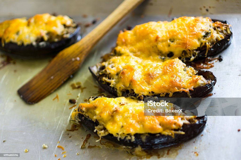 Boats of eggplant zucchini stuffed with meat on baking tray Boats of eggplant zucchini stuffed with meat, rice, tomato and mushrooms with grated cheese on baking tray Beef Stock Photo