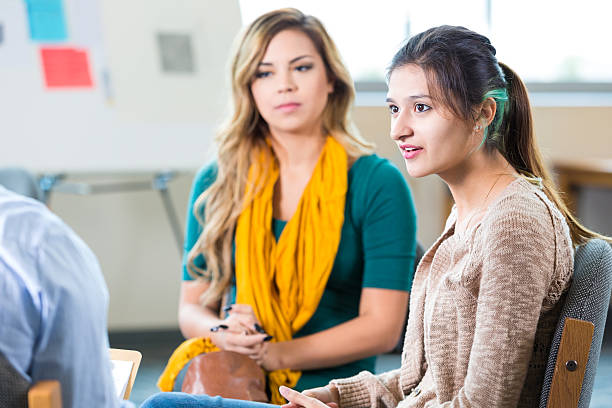 istock Trendy college age women discussing something in class or therapy 499686614