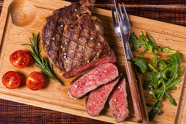 istock Ribeye steak with arugula and tomatoes. 499686710