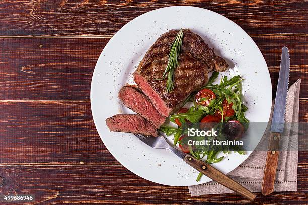 Ribeye Steak With Arugula And Tomatoes Stock Photo - Download Image Now - Steak, Plate, Rib Eye Steak
