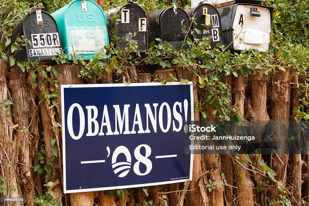 "OBAMANOS!" Poster on Traditional Coyote Fence, Santa Fe, NM Santa Fe, USA - October 12, 2008: An "OBAMANOS! 08" poster on a traditional coyote fence under mailboxes in Santa Fe, NM. The slogan was a popular one among Spanish-speaking Obama supporters in the Southwest USA. 2008 Stock Photo