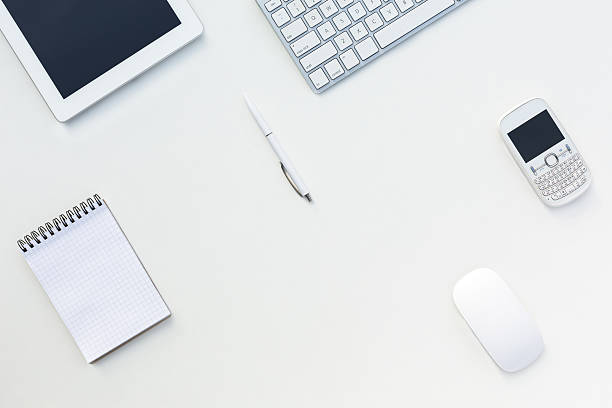 White Office Desk Table Computer Keyboard Other Gadgets and Stationery