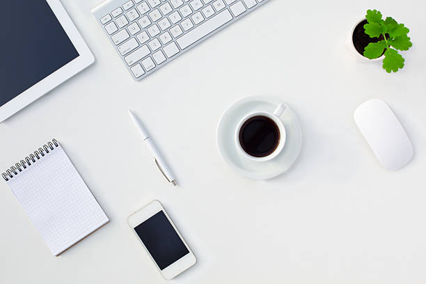 istock White Office Desk Table Electronic Gadgets Stationery Coffee Cup Flower 499691622
