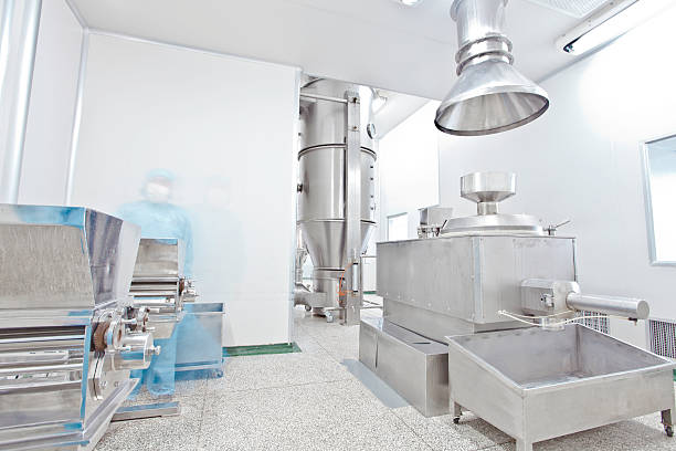istock pharmaceutical factory equipment working in clean room 499694179