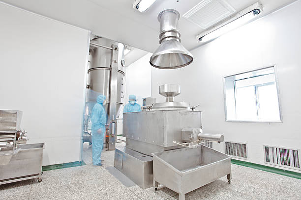 istock pharmaceutical factory equipment working in clean room 499694181