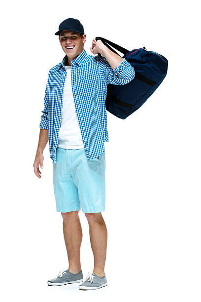 istock Happy young man standing with duffle bag 499694701