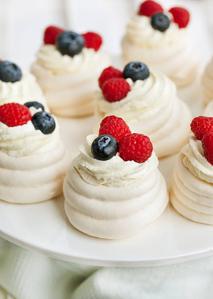 istock Pavlova meringue cakes decorated with fresh berries 499694920