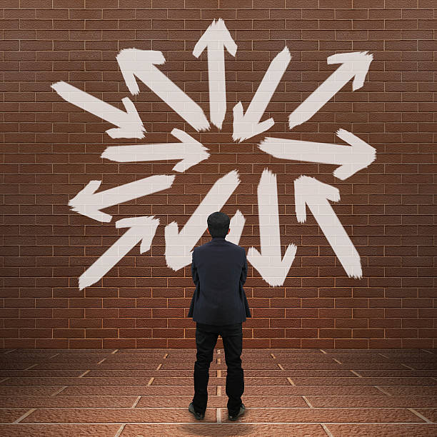 istock Businessman looking at arrows 499695803