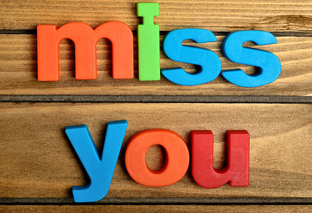 Colorful miss you word on wooden table